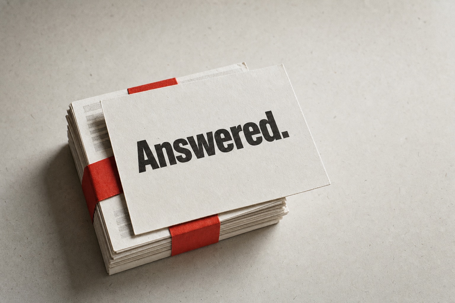 Bundle of message cards tied with a vermilion paper band; the top card carries the word «Answered.»